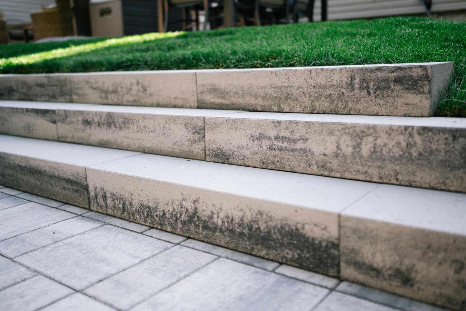 Stone patio with steps in a Tower Hill backyard in Okotoks