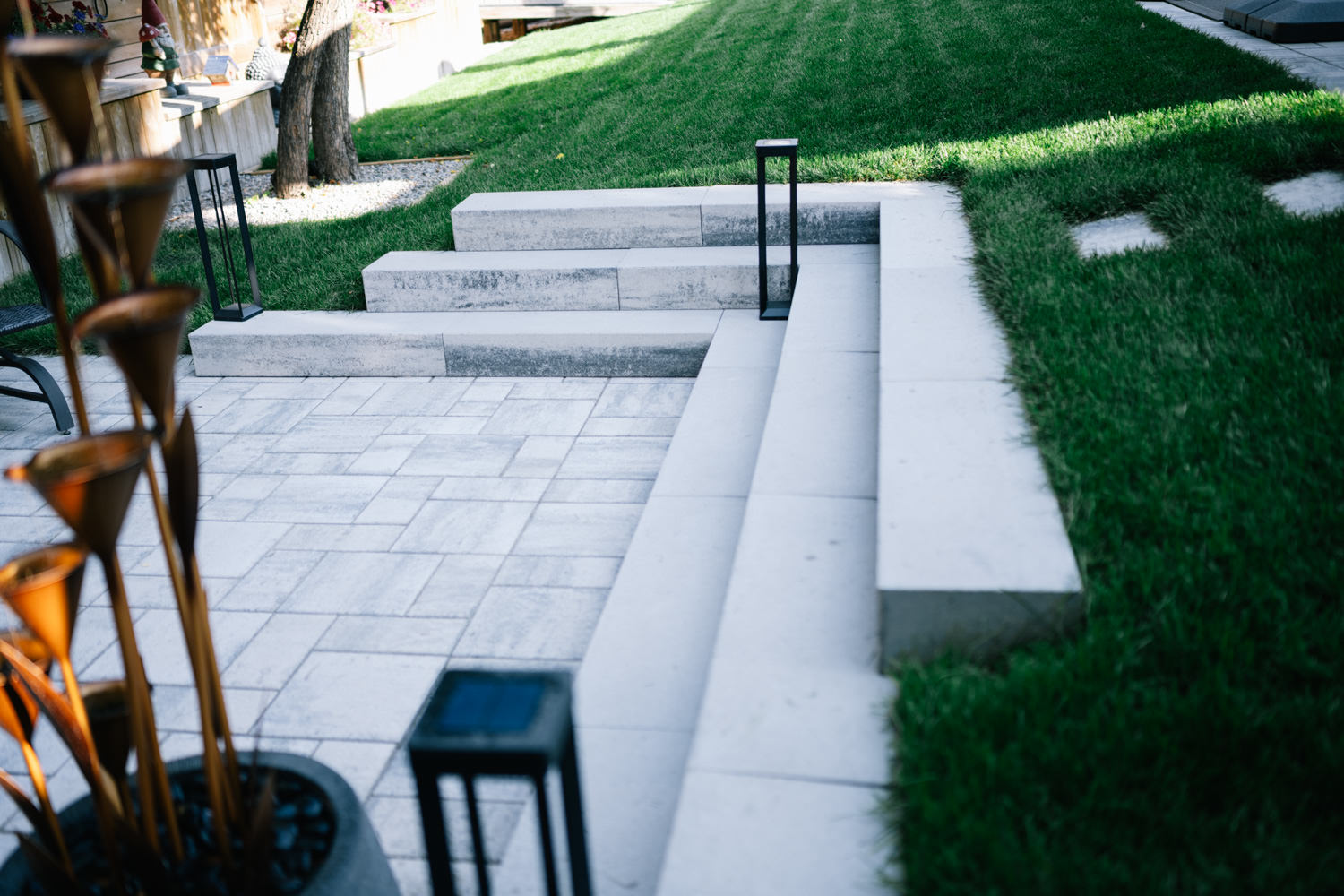 Patio with stone steps in a Tower Hill backyard in Okotoks