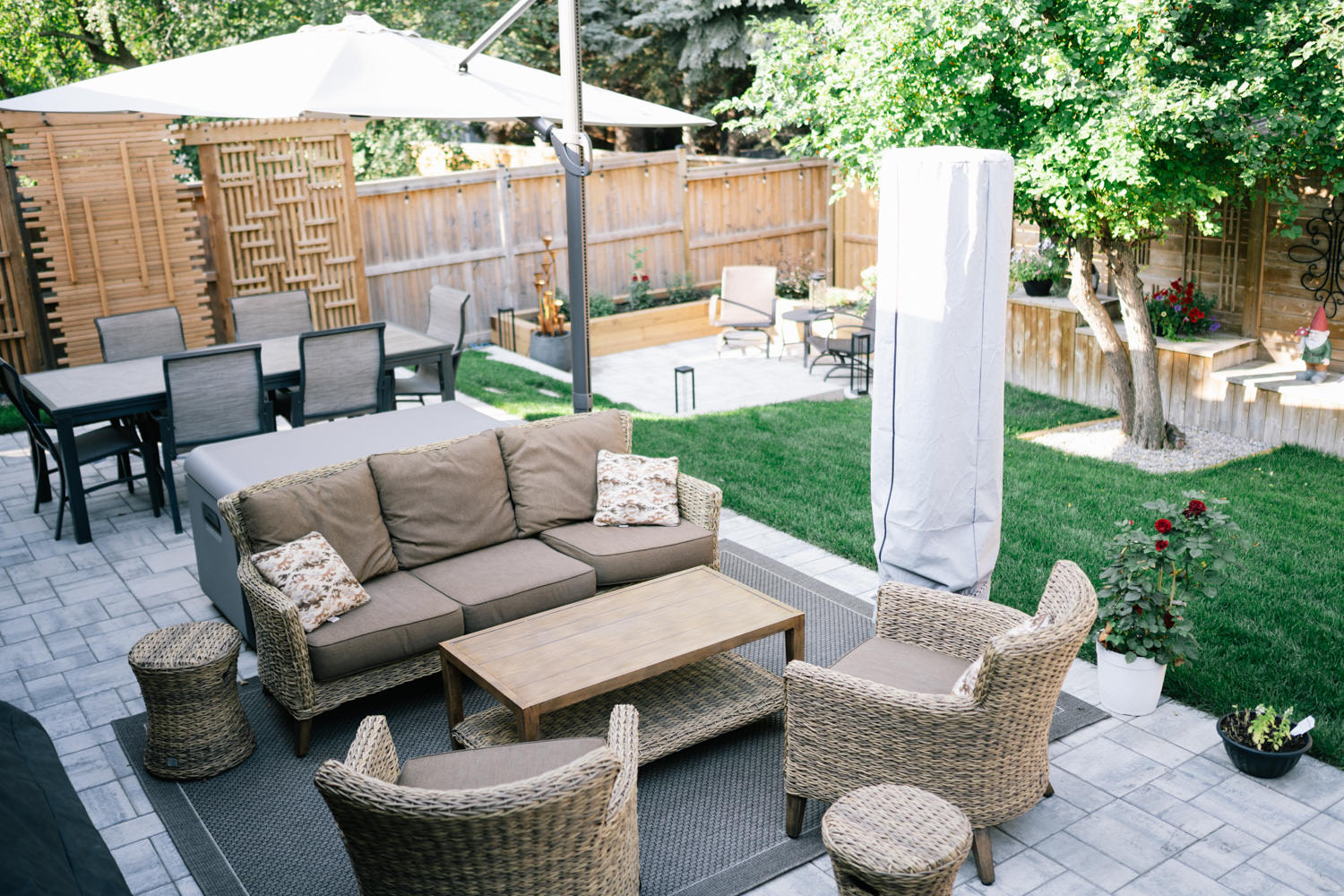Stone patio seating area in a Tower Hill backyard in Okotoks