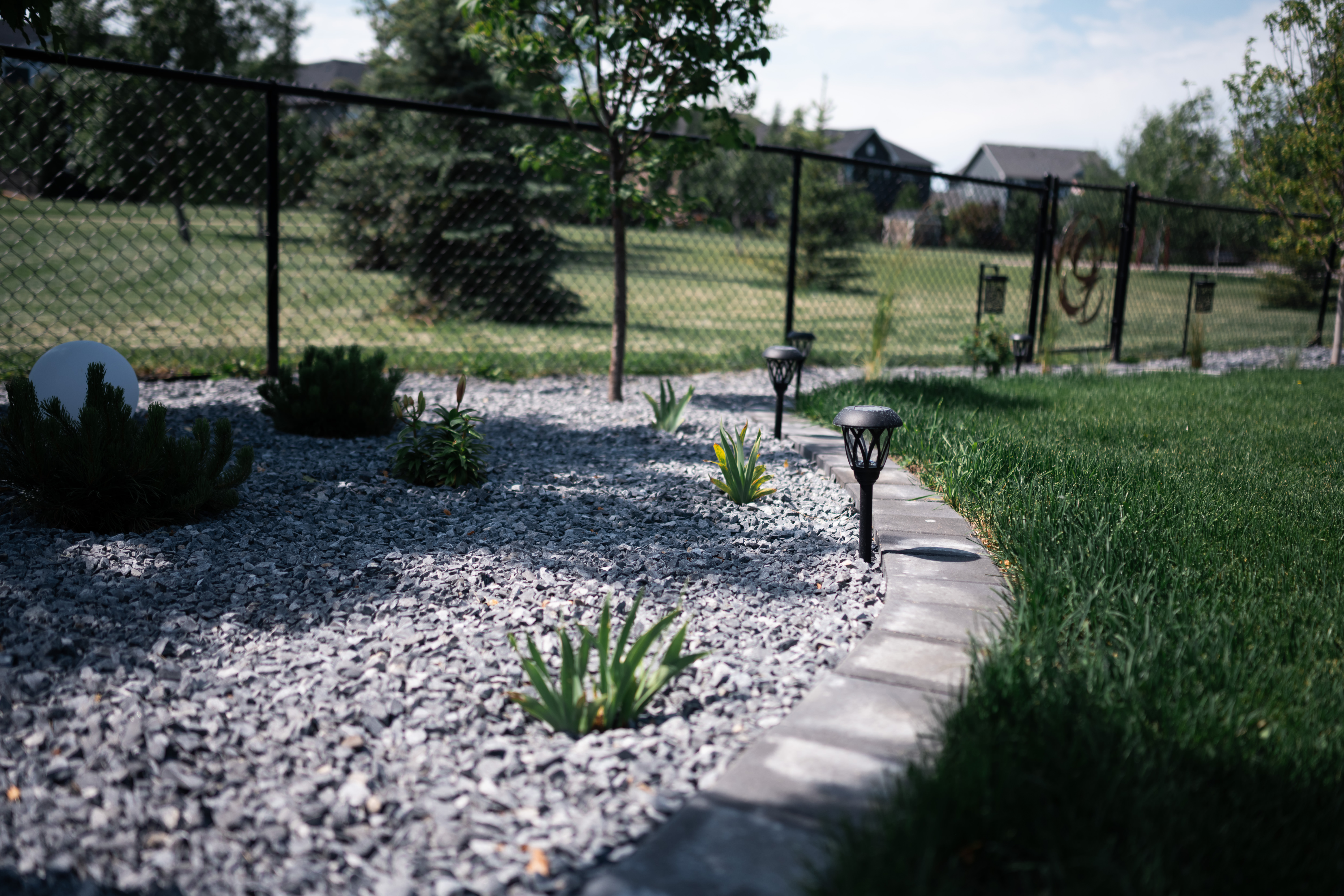 Air Ranch backyard in Okotoks with stone edging and fresh sod
