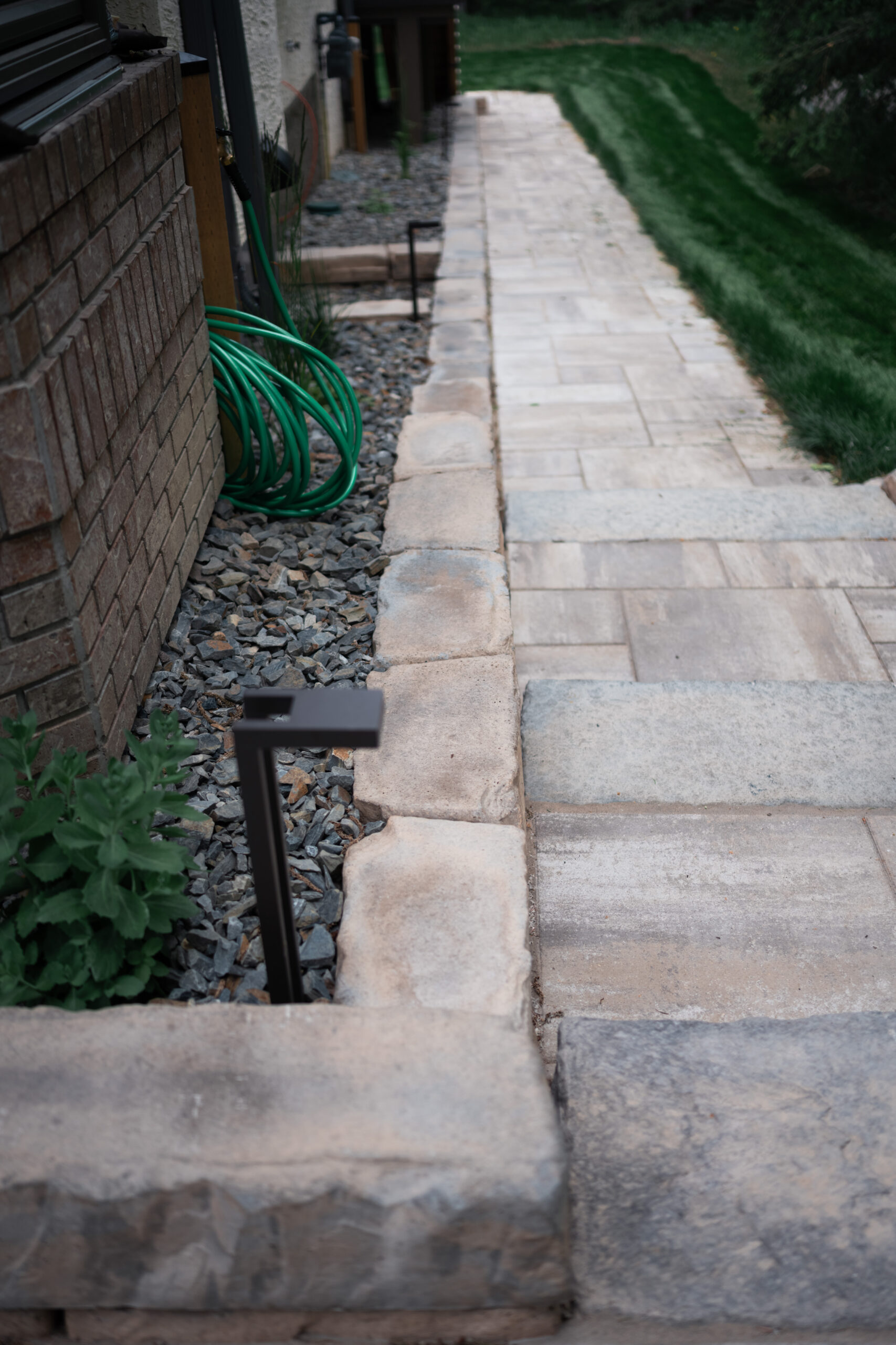 Stone pathway through a landscaped yard in Priddis Greens