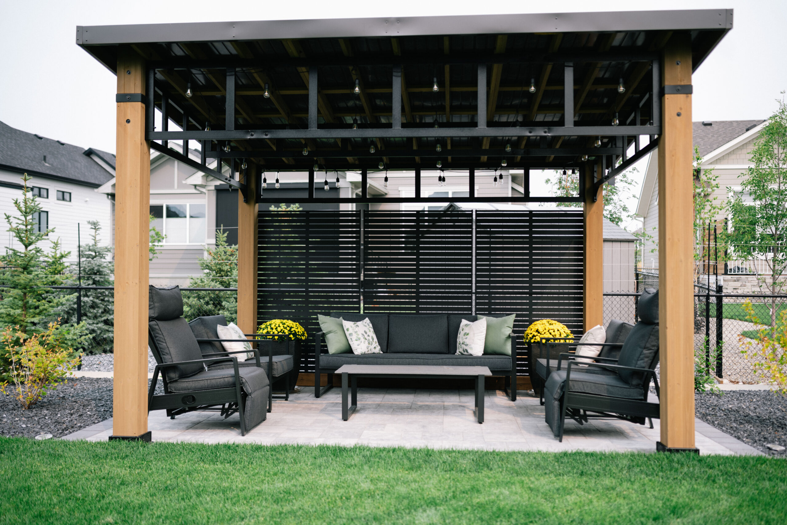 Stone patio with seating area in an Okotoks Cimarron Estates backyard
