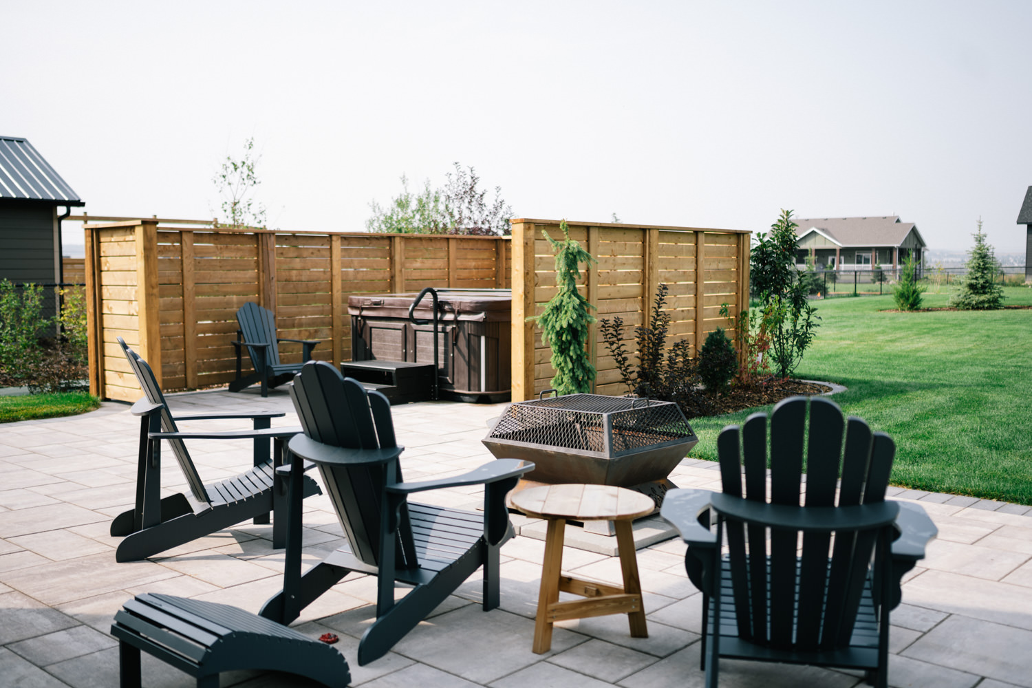 Stone patio with grass in a Green Haven acreage yard in Okotoks