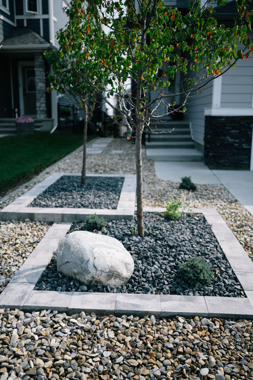 Front yard in Rancher’s Way, Okotoks with modern landscape design and geometric shapes