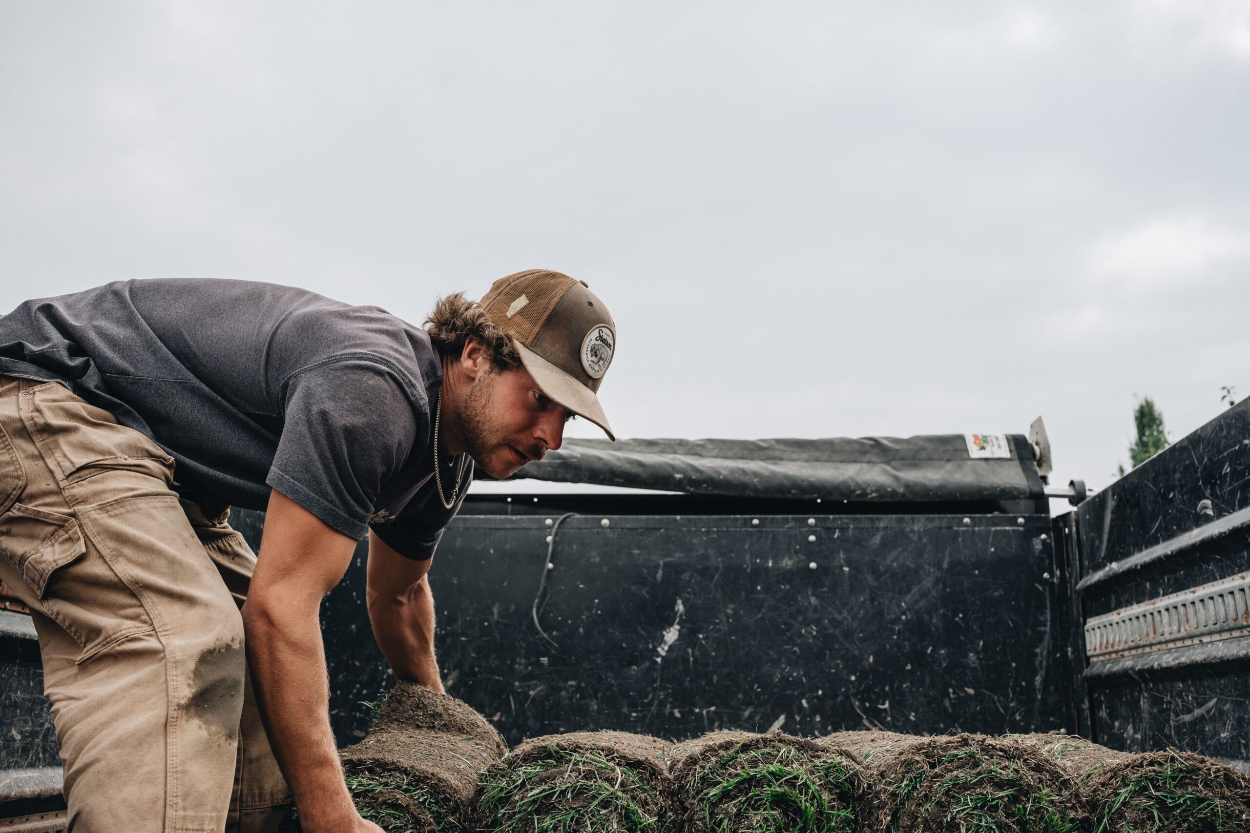 Kayben team member working by hand on a landscape construction site